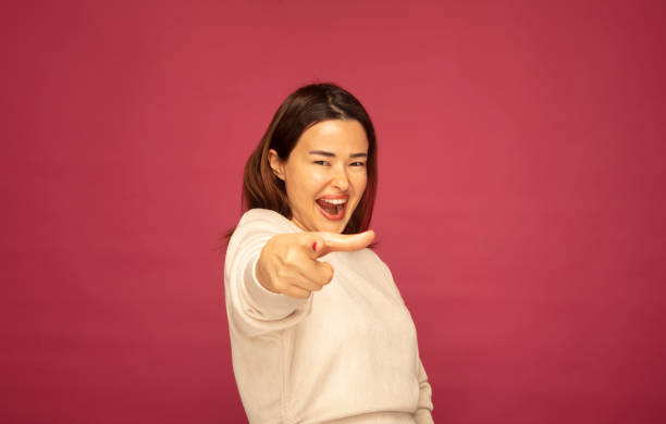 istock Asian young woman pointing at the camera with her hand while screaming. 1306577062