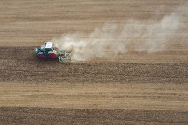 istock Tractor working in field, aerial view 1306578056