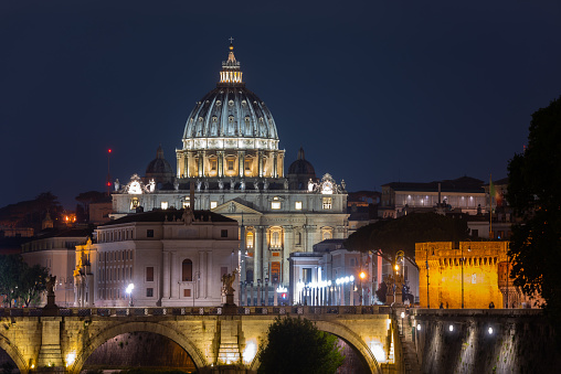 Vatican, 05/26/2019. Vatican Cathedral of St. Peter and illuminated neighboring buildings on a summer evening