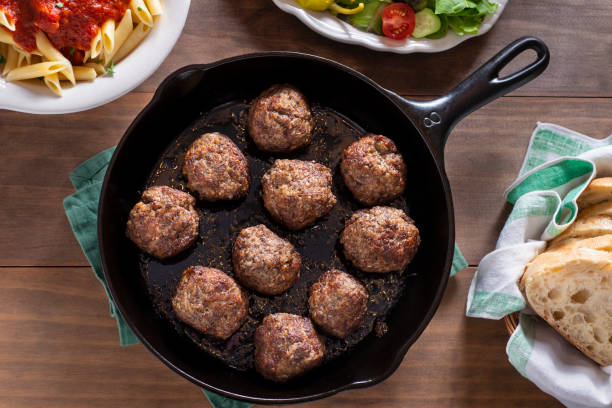 Meatballs Homemade Meatballs with Pasta, Salad and Italian Bread. penne meatballs stock pictures, royalty-free photos & images