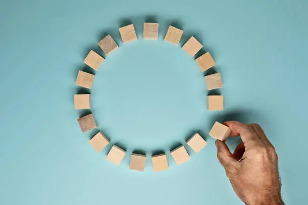 Blocks made out of wood in a circle on a blue background