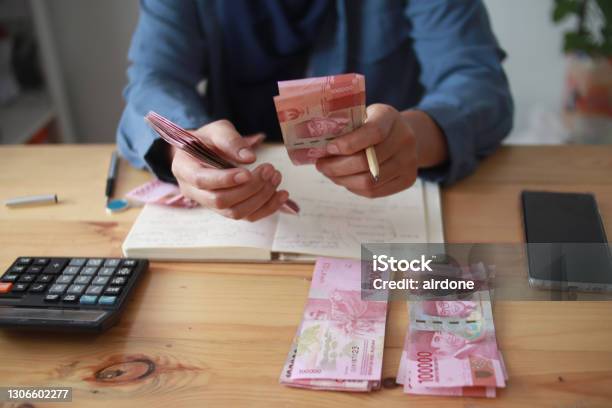 Close Up Of Woman Hand Counting Money Uang Indonesian Rupiah And Making Notes Money Financial Management Stock Photo - Download Image Now