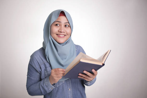 istock Muslim Woman Reading Book and Thinking 1306602954