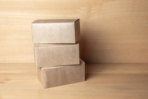 istock Packaging boxes for cakes, gifts or parcels on a wooden table. 1306605640