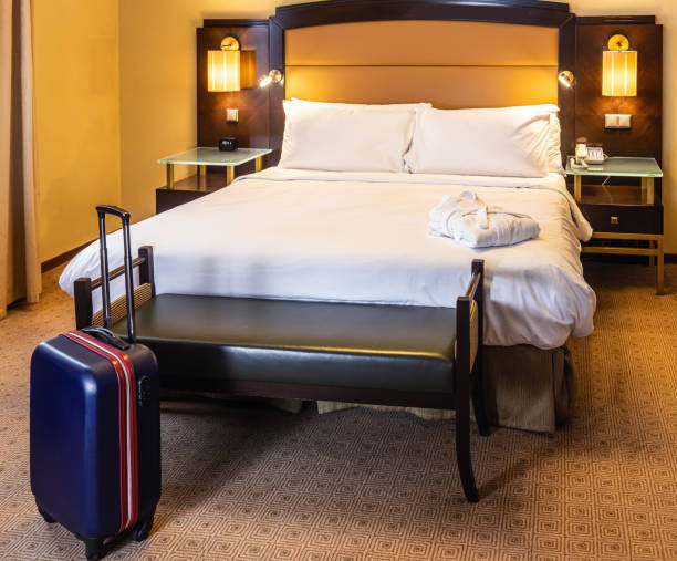 istock suitcase stands by the bed in the hotel room 1306606564
