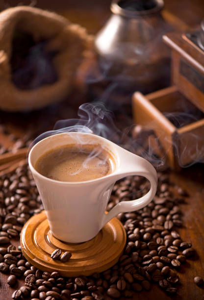 istock cup of coffee and coffee beans in a sack on dark background, top view 1306606793