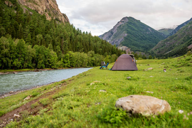istock hiking tent on the beach of river. 1306606808