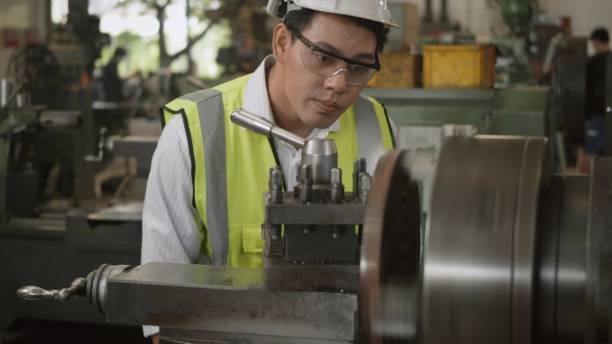 istock professional mechanical engineer or operation man wear uniform goggles safety working on workshop metal lathe industrial 1306610125