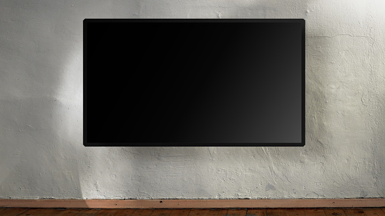 Gran pantalla plana negra vacía colgando en la pared de hormigón blanco. photo