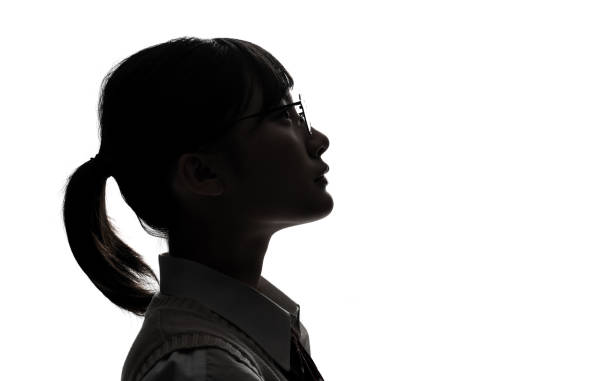 silhouette of asian high school girl. - serious women asian ethnicity human face imagens e fotografias de stock