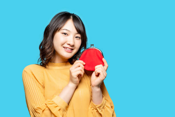 istock Young asian girl holding a wallet. 1306611130