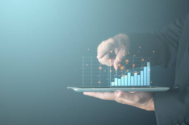 businessman finger touch uptrend bar graph on virtual screen tablet computer show financial profit and revenue growth of personal investment