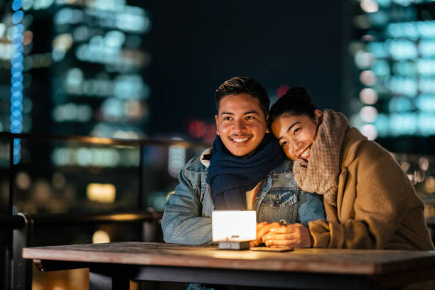 istock Young multi-ethnic couple flirting at night 1306611880