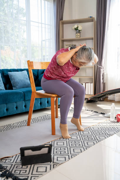 istock Senior woman stretch back muscles for exercise at home 1306611984