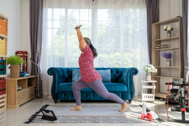 istock Retirement woman doing exercise at home during quarantine 1306612027