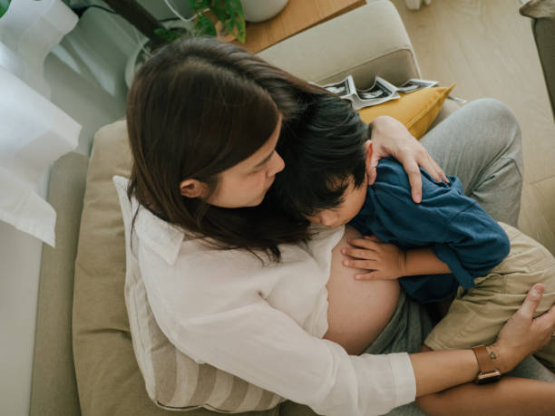 Asian sibling with woman pregnant