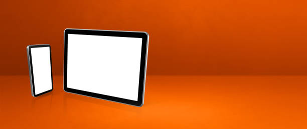 istock Mobile phone and digital tablet pc on orange office desk. Background banner 1306617623