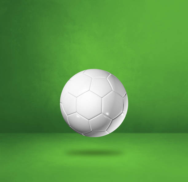 istock White soccer ball on a green studio background 1306618299