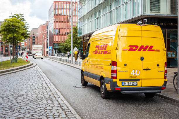 DHL delivery van parked on a street in Germany stock photo