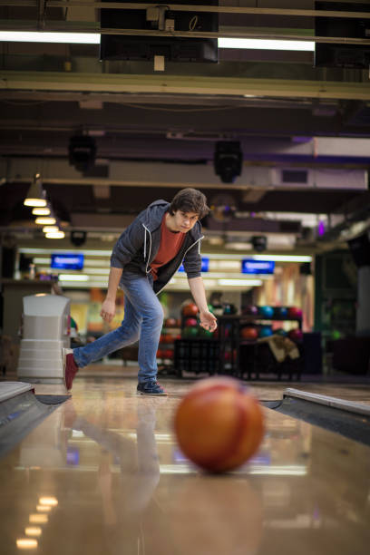 istock Young man playing bowling game. Focus is on man. 1306620727