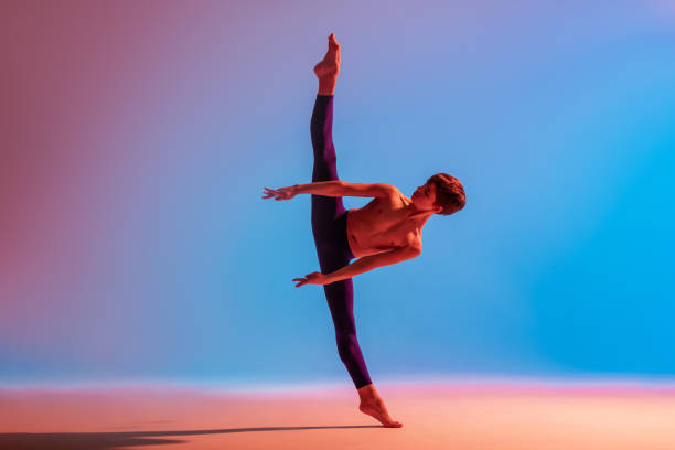 istock teenage ballet dancer dances barefoot under colored light. 1306620818