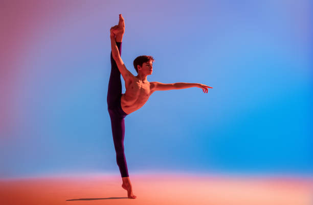 istock teenage ballet dancer dances barefoot under colored light. 1306620819