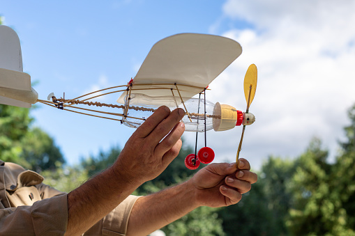 Grandfather made a model of an airplane with a propeller for his grandson from plastic and household waste. High quality photo