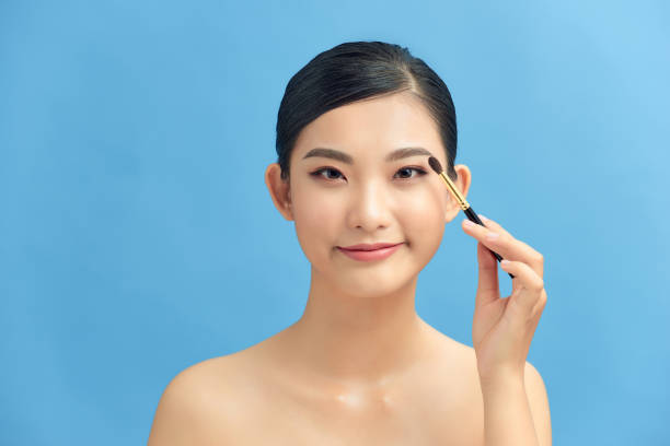 istock Beautiful and professional make up artist using brush and blusher 1306622864