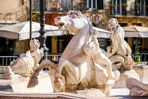 A detail of the mythological statue of the hippocampus in the sculptural group of the Fountain of Neptune in Piazza Navona, in the heart of Rome, built in 1873 on a project by the architect Giacomo della Porta. Image in high definition format.