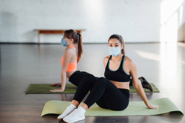 istock Young women doing push up exercise in room during morning 1306624286