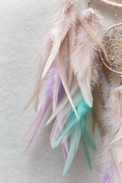 istock Handmade dream catcher with feathers threads and beads rope hanging on white background 1306627836