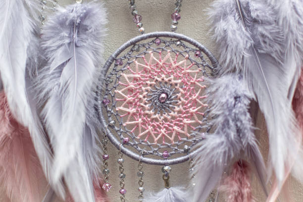 istock Handmade dream catcher with feathers threads and beads rope hanging on white background 1306627965