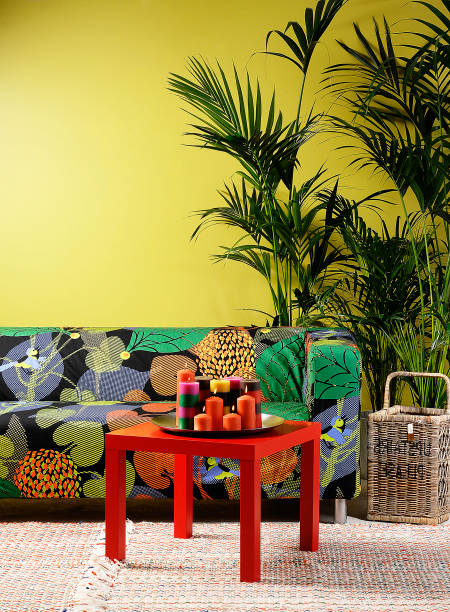 Young woman relaxing and reading a book on a sofa at eco hotel