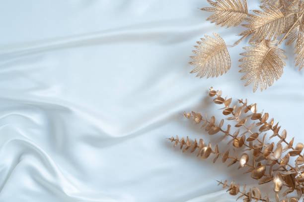 istock Gold tropical palm leaves Monstera on white background. Flat lay 1306628937