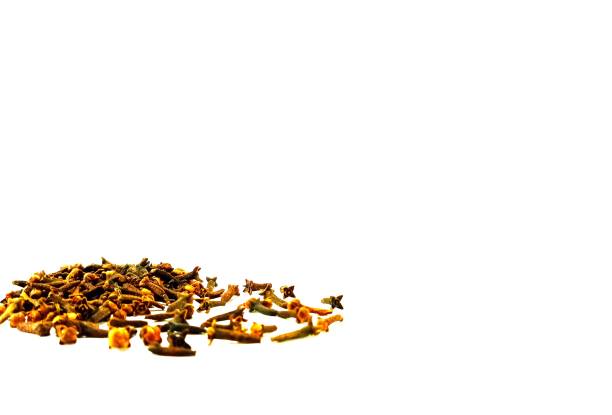 Heap of sprinkled cloves on a white background