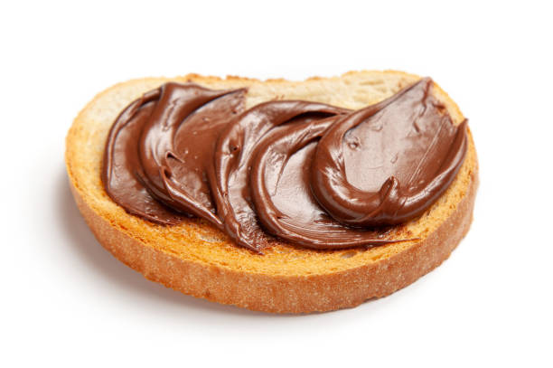 istock toasted bread with chocolate hazelnut cream isolated on white background, selective focus 1306634767