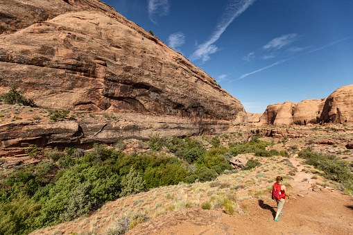 Under Corona arch: Woman hiking near Canyonlands, Moab