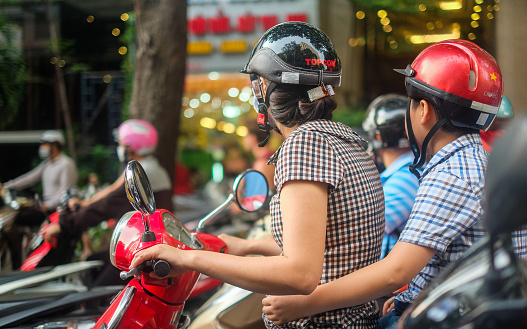 Mother and son riding a motorbike in Ho Chi Minh City, Vietnam, May 2019