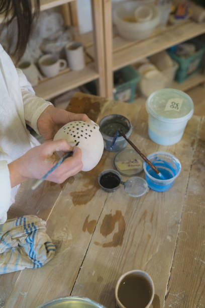 istock Female ceramist working in her studio 1306636445