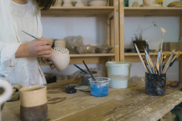 istock Female ceramist working in her studio 1306636452