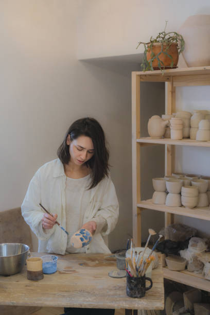 istock Female ceramist working in her studio 1306636462