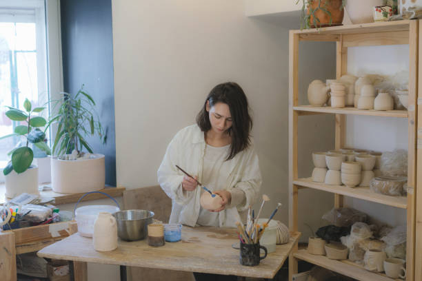 istock Female ceramist working in her studio 1306636479