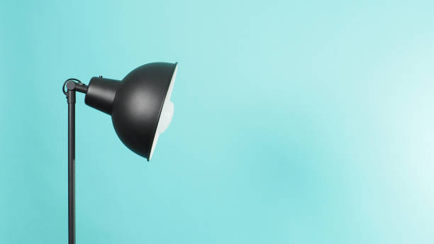istock Lamp Floor uplighter.In black color and Light bulb made with  Metal, rugged constructions on green or mint or Tiffany Blue background. 1306636613