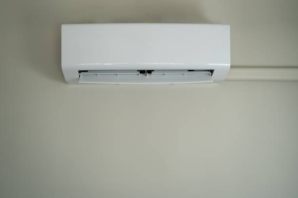 istock Air conditioner inside top the room man operating remote controller open air conditioner energy savings 1306636814