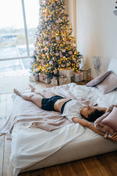 istock Attractive young woman stretching in bed happy concept 1306636865