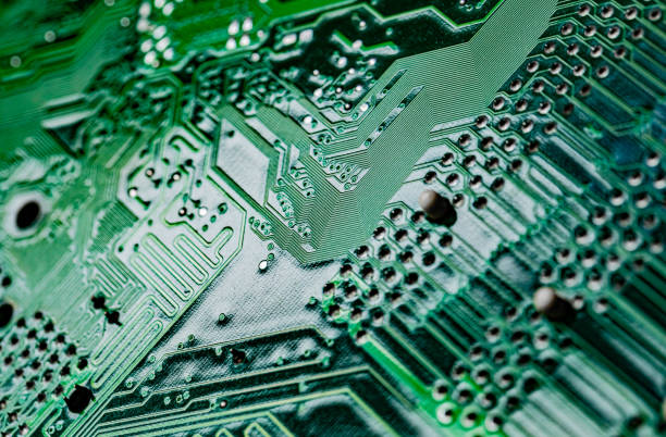 macro close up of printed wiring on pc circuit board - connection block order green colors imagens e fotografias de stock