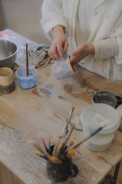 istock Female ceramist working in her studio 1306639287