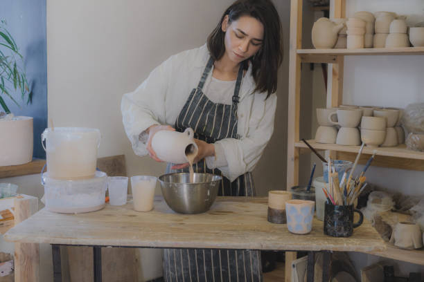istock Female ceramist working in her studio 1306639288
