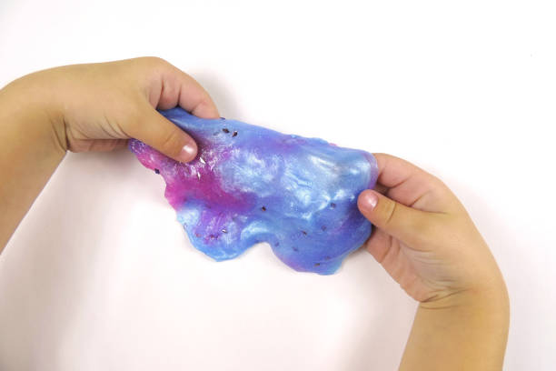 istock Child plays with neon  transparent slime with glitter inside  , childhood, 1306641048