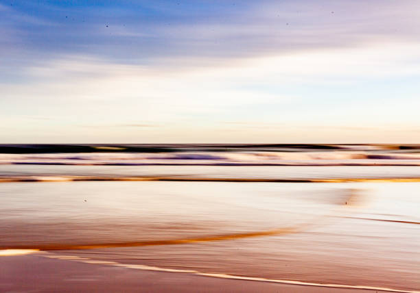 istock Abstract intentional camera movement shot of beach and ocean at sunset 1306643161